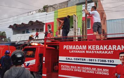 petugas dan warga saat membantu memadamkan api