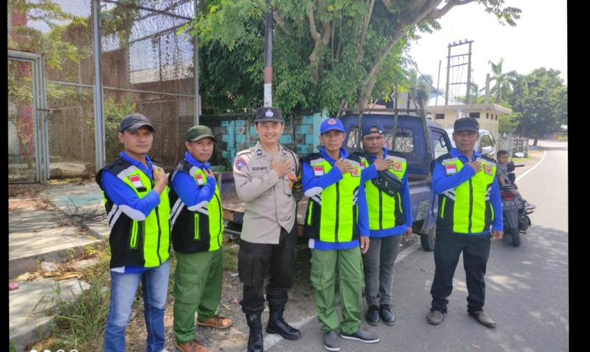 Bhabinkamtibmas Polsek Teluk Segara Monitoring dan Atur Lalin di Pesta Pernikahan Warga
