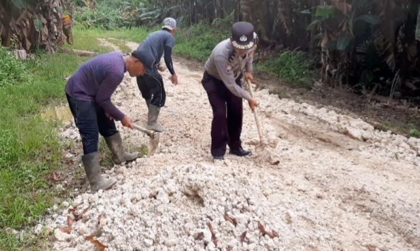 Warga Bersama Bhabinkamtibmas Aipda M Harahap Gotong Royong Timbun Jalan Berlubang